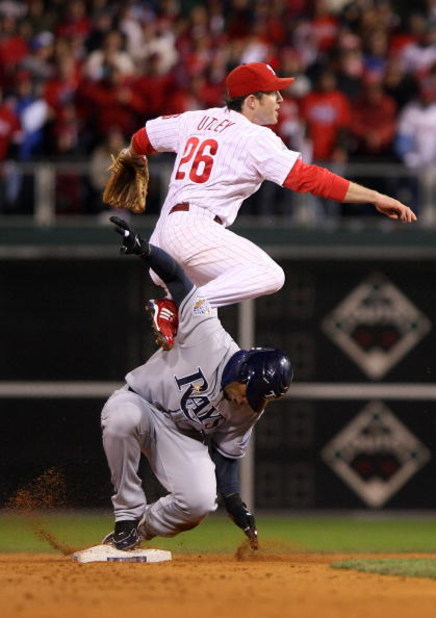 PHILADELPHIA - OCTOBER 29:  Chase Utley #26 of the Philadelphia Phillies turns a successful double play over Carl Crawford #13 of the Tampa Bay Rays on a ball hit by B.J. Upton #2 in the top of the eighth inning during the continuation of game five of the