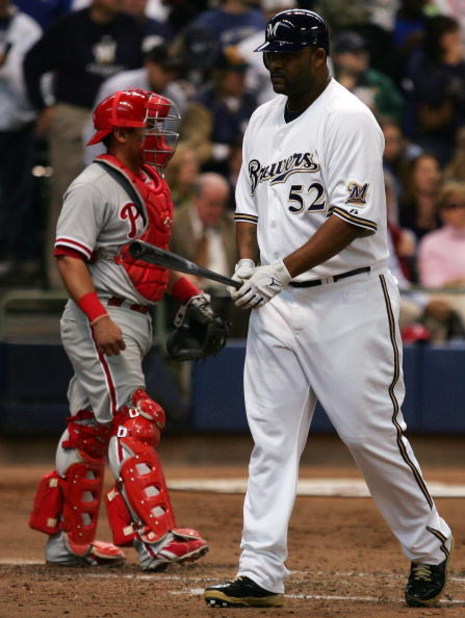 MILWAUKEE - OCTOBER 05:  Pinch hitter C.C. Sabathia #52 of the Milwaukee Brewers walks back to the dugout past catcher Carlos Ruiz #51 of the Philadelphia Phillies after striking out in game four of the NLDS during the 2008 MLB playoffs at Miller Park on 