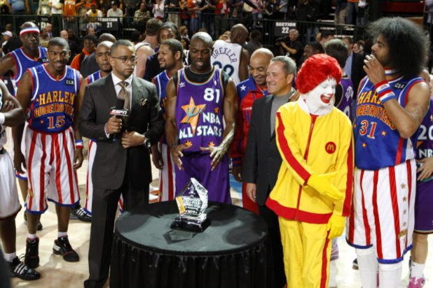 PHOENIX - FEBRUARY 13: Terrell Owens of the Dallas Cowboys poses with his MVP trophy and McDonald's executives during during the McDonald's All-Star Celebrity Game held at the Phoenix Convention Center on February 13, 2009 in Phoenix, Arizona. (Photo by