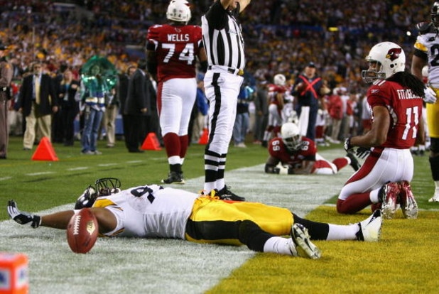 TAMPA, FL - FEBRUARY 01: James Harrison #92 of the Pittsburgh Steelers reacts after scoring a touchdown on an 100 yards interception return in the second quarter as Larry Fitzgerald #11 of the Arizona Cardinals looks on during Super Bowl XLIII on Februar