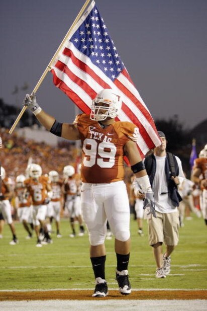 AUSTIN, TX - OCTOBER 18: Roy Miller #99 of the Texas Longhorns carries an American flag onto the field before the game against the Missouri Tigers on October 18, 2008 at Darrell K Royal-Texas Memorial Stadium in Austin, Texas. Texas won 56-31. (Photo b