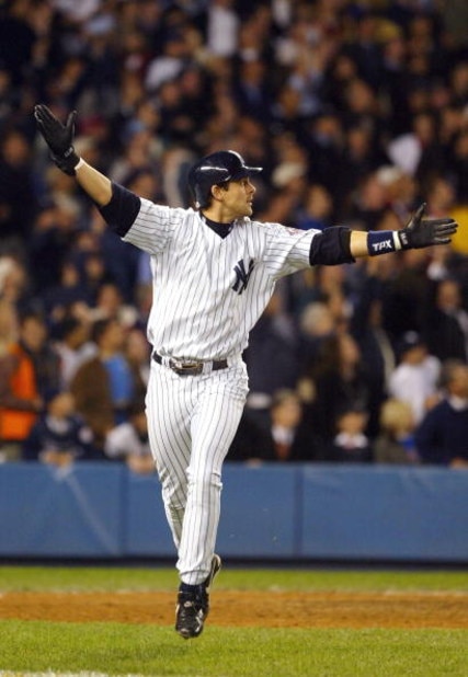 BRONX, NY - OCTOBER 16: Aaron Boone #19 of the New York Yankees celebrates after hitting the game-winning home run in the bottom of the eleventh inning against the Boston Red Sox during game 7 of the American League Championship Series on October 16, 200