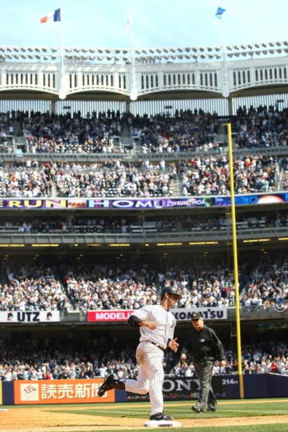 NEW YORK - APRIL 16: Jorge Posada #20 of the New York Yankees rounds the bases after hitting a solo home run in the fifth inning against the Cleveland Indians during opening day at the new Yankee Stadium on April 16, 2009 in the Bronx borough of New York