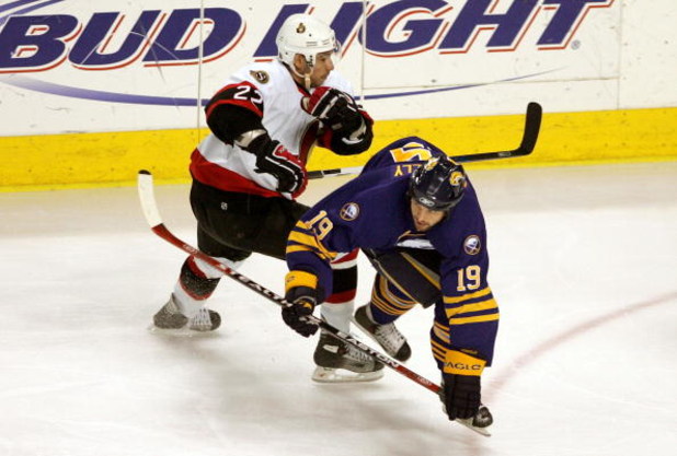BUFFALO, NY - MAY 19:  Tim Connolly #19 of the Buffalo Sabres is pushed down by Chris Kelly #22 of the Ottawa Senators during the first period of Game 5 of the 2007 Eastern Conference Finals on May 19, 2007 at the HSBC Center in Buffalo, New York.  (Photo