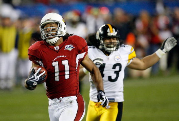 TAMPA, FL - FEBRUARY 01:  Wide receiver Larry Fitzgerald #11 of the Arizona Cardinals scores a 64-yard touchdown reception in the fourth quarter against Troy Polamalu #43 of the Pittsburgh Steelers during Super Bowl XLIII on February 1, 2009 at Raymond Ja