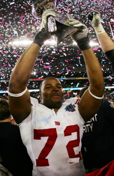 GLENDALE, AZ - FEBRUARY 03:  Osi Umenyiora #72 of the New York Giants holds the Vince Lombardi Trophy after defeating the New England Patriots 17-14 in Super Bowl XLII on February 3, 2008 at the University of Phoenix Stadium in Glendale, Arizona.  (Photo 