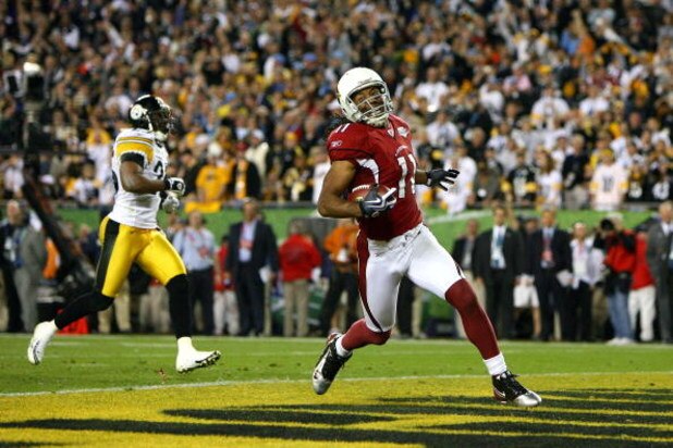 TAMPA, FL - FEBRUARY 01: Larry Fitzgerald #11 of the Arizona Cardinals celebrates after scoring on a 64-yard touchdown reception in the fourth quarter against the Pittsburgh Steelers during Super Bowl XLIII on February 1, 2009 at Raymond James Stadium in