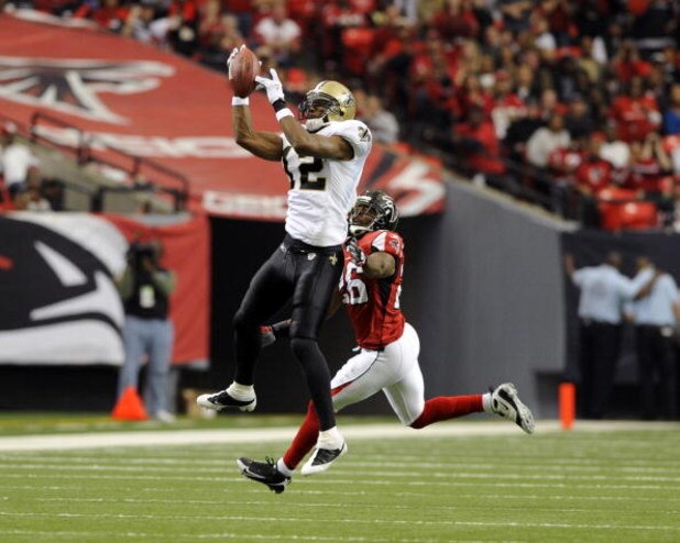 ATLANTA - NOVEMBER 9: Wide receiver Marques Colston #12 of the New Orleans Saints grabs a midfield pass against the Atlanta Falcons at the Georgia Dome on November 9, 2008 in Atlanta, Georgia. (Photo by Al Messerschmidt/Getty Images)