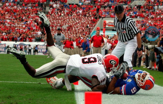 JACKSONVILLE, FL - OCTOBER 27:  Wide receiver Louis Murphy #9 of the Florida Gators makes a touchdown pass reception against Reshad Jones #9 of the Georgia Bulldogs at Jacksonville Municipal Stadium on October 27, 2007 in Jacksonville, Florida.  (Photo by