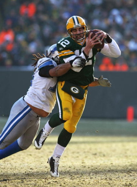 GREEN BAY, WI - DECEMBER 28: Aaron Rodgers #12 of the Green Bay Packers is brought down by Ikaika Alamam-Francis #97 of the Detroit Lions on December 28, 2008 at Lambeau Field in Green Bay, Wisconsin. The Packers defeated the Lions 31-21. (Photo by Jonath
