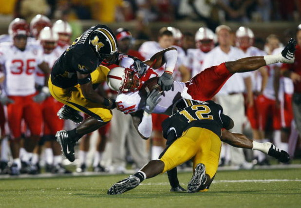 COLUMBIA, MO - OCTOBER 6:  Maurice Purify #16 of the Nebraska Cornhuskers is upended by Sean Weatherspoon #12 and Justin Garrett #8 of the Missouri Tigers during 2nd-half action on October 6, 2007 at Faurot Field in Columbia, Missouri.  Missouri won 41-6.