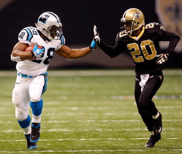NEW ORLEANS - DECEMBER 28:  Jonathan Stewart #28 of the Carolina Panthers avoids a tackle by Randall Gay #20 of the New Orleans Saints on December 28, 2008 at the Superdome in New Orleans, Louisiana. The Panthers defated the Saints 33-31.  (Photo by Chris