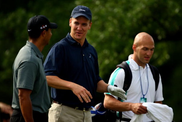 CHARLOTTE, NC - APRIL 29:  Colts Quarterback Peyton Manning talks to Tiger Woods as Peyton's caddy and teamate Anthony Gonzalez looks on during the Pro-Am for the Quail Hollow Championship at Quail Hollow Golf Club on April 29, 2009 in Charlotte, North Ca