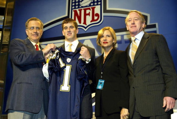 NEW YORK - APRIL 24:  Eli Manning (2nd-L) with his parents receives a San Diego Chargers jersey from NFL Commissioner Paul Tagliabue during the 2004 NFL Draft on April 24, 2004 at Madison Square Garden in New York City. Manning was selected first pick ove