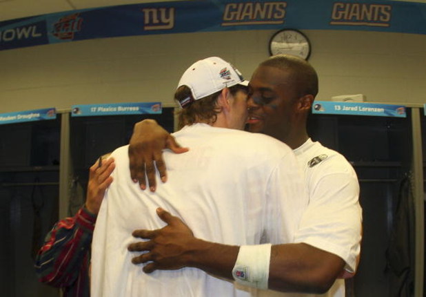 GLENDALE, AZ - FEBRUARY 03:  Wide receiver Plaxico Burress #17 of the New York Giants in (R) hugs quarterback Eli Manning #10 the locker room after defeating the New England Patriots 17-14 during Super Bowl XLII on February 3, 2008 at the University of Ph