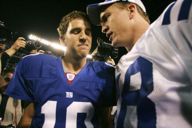 EAST RUTHERFORD, NJ - SEPTEMBER 10:  Quarterback Eli Manning #10 of the New York Giants (L) congratulates his brother quarterback Peyton Manning #18 of the Indianapolis Colts on his 26-21 victory on September 10, 2006 at Giants Stadium in East Rutherford,