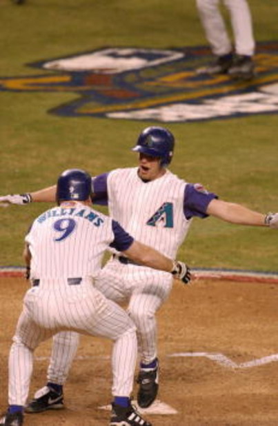 4 Nov 2001: Jay Bell #48 of the Arizona Diamondbacks is met at home plate by teammate Matt Williams #9 as he scores the winning run in the ninth inning against the New York Yankees during game seven of the Major League Baseball World Series at Bank One Ba