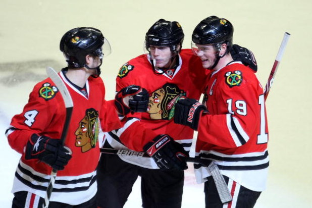 CHICAGO - MAY 11:  (L-R) Niklas Hjalmarsson #4, Patrick Kane #88 and Jonathan Toews #19 of the Chicago Blackhawks celebrate after Kane scored his second goal of the game in the third period against the Vancouver Canucks during Game Six of the Western Conf