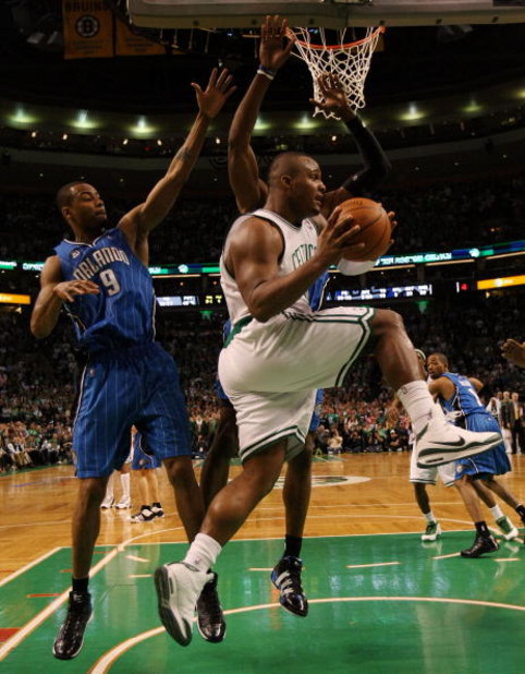 BOSTON - MAY 12:  Glen Davis #11 of the Boston Celtics passes the ball as Rashard Lewis #9 and Dwight Howard #12 of the Orlando Magic defend in Game Five of the Eastern Conference Semifinals during the 2009 NBA Playoffs at TD Banknorth Garden May 12, 2009