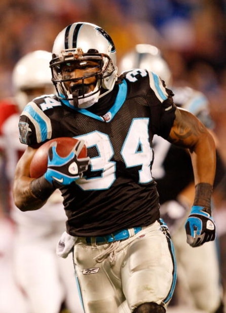 CHARLOTTE, NC - JANUARY 10: Running back DeAngelo Williams #34 of the Carolina Panthers runs the ball against the Arizona Cardinals during the first quarter of the NFC Divisional Playoff Game on January 10, 2009 at Bank of America Stadium in Charlotte, N