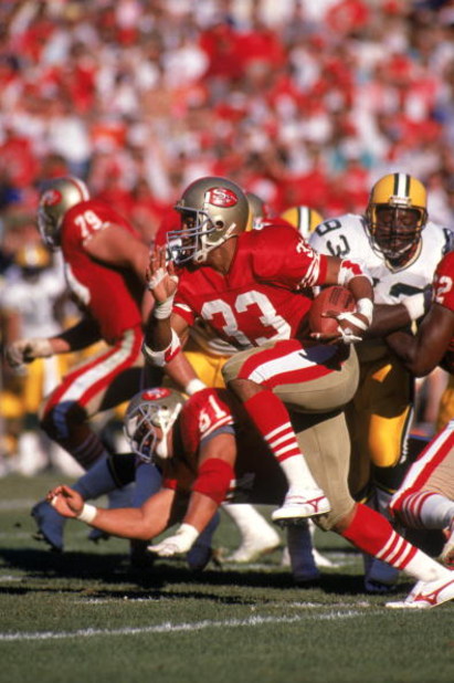 SAN FRANCISCO - NOVEMBER 19:  Running back Roger Craig #33 of the San Francisco 49ers looks for room to run against the Green Bay Packers defense during a game at Candlestick Park on November 19, 1989 in San Francisco, California.  The Packer won 21-17.  