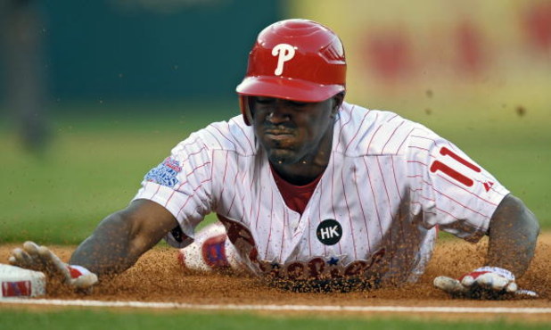 PHILADELPHIA - APRIL 17: Jimmy Rollins #11 of the Philadelphia Phillies slides into first base on a pickoff play during the game against San Diego Padres the on April 17, 2009 at Citizens Bank Park in Philadelphia, Pennsylvania. The Padres won 8-7.  (Phot