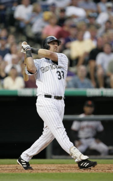 DENVER - JULY 17:  Right fielder Larry Walker #33 of the Colorado Rockies watches the flight of the ball as he follows through on a swing during the game against the San Francisco Giants at Coors Field on July 17, 2004 in Denver, Colorado.  The Giants won