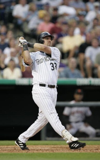 DENVER - JULY 17: Right fielder Larry Walker #33 of the Colorado Rockies watches the flight of the ball as he follows through on a swing during the game against the San Francisco Giants at Coors Field on July 17, 2004 in Denver, Colorado. The Giants won