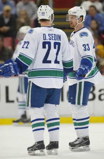 DETROIT - JANUARY 17:  The Sedin brothers Daniel #22 and Henrik #33 of the Vancouver Canucks chat prior to a faceoff in a game against the Detroit Red Wings on January 17, 2008 at the Joe Louis Arena in Detroit, Michigan. The Wings defeated the Canucks 3-