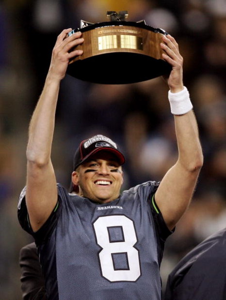 SEATTLE - JANUARY 22:  Quarterback Matt Hasselbeck holds up the NFC Championship trophy following his team's victory over the Carolina Panthers at Qwest Stadium on January 22, 2006 in Seattle, Washington. Seattle will play Pittsburgh in Super Bowl XL.  (P
