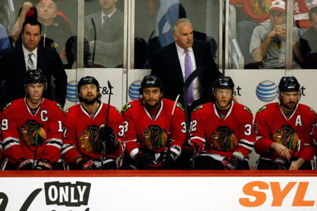 CHICAGO - MAY 24:  (L-R) Jonathan Toews #19, Adam Burish #37, Dustin Byfuflien #33, head coach Joel Quenneville, Kris Versteeg #32 and Patrick SHarp #10 of the Chicago Blackhawks look on from the bench dejected late in the game against the Detroit Red Win