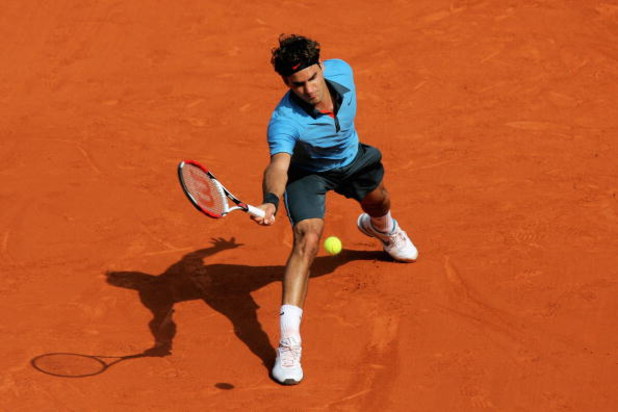 PARIS - MAY 25:  Roger Federer of Switzerland hits a forehand during his Men's Singles First Round match against Alberto Martin of Spain at the French Open on May 25, 2009 in Paris, France.  (Photo by Matthew Stockman/Getty Images)