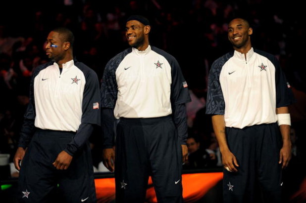 PHOENIX - FEBRUARY 15:  (L-R) Dwyane Wade, LeBron James and Kobe Bryant, members of the women's and men's gold medal winning USA Olympic basketball teams, wave to the crowd during half time of the 58th NBA All-Star Game, part of 2009 NBA All-Star Weekend 