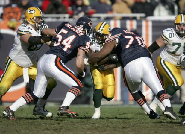 CHICAGO - DECEMBER 4:  Brian Urlacher #54 and Alfonso Boone #70 of the Chicago Bears create a roadblock against Samkon Gado #35 of the Green Bay Packers as Grey Ruegamer #67 of the Packers blocks during their game on December 4, 2005 at Soldier Field in C