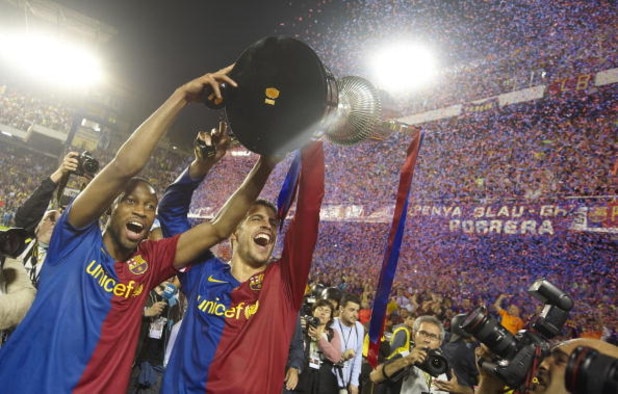 VALENCIA, SPAIN - MAY 13: Seydou Keita (lL) of Barcelona celebrates with team mate Gerad Pique after winning the Copa del Rey final match between Barcelona and Athletic Bilbao at the Mestalla stadium on May 13, 2009 in Valencia, Spain. Barcelona won 3-1