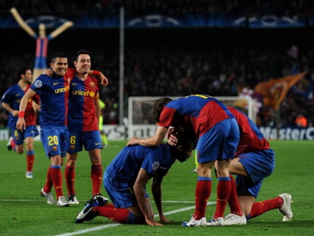 BARCELONA, SPAIN - MARCH 11: Seydou Keita (C) of Barcelona sits on his knees celebrates scoring during the UEFA Champions League, First knock-out round, second leg match between Barcelona and Lyon at the Camp Nou stadium on March 11, 2009 in Barcelona, S