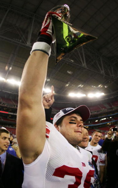 GLENDALE, AZ - FEBRUARY 03:  Madison Hedgecock #39 of the New York Giants holds the Vince Lombardi Trophy after defeating the New England Patriots 17-14 in Super Bowl XLII on February 3, 2008 at the University of Phoenix Stadium in Glendale, Arizona.  (Ph