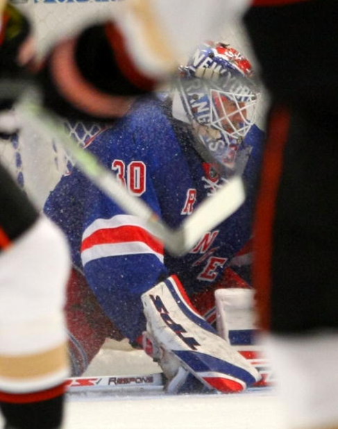 NEW YORK - JANUARY 20: Henrik Lundqvist #30 of the New York Rangers searches for the puck in a crowd against the Anaheim Ducks on January 20, 2009 at Madison Square Garden in New York City. The Rangers defeated the Ducks 4-2. (Photo by Bruce Bennett/Getty