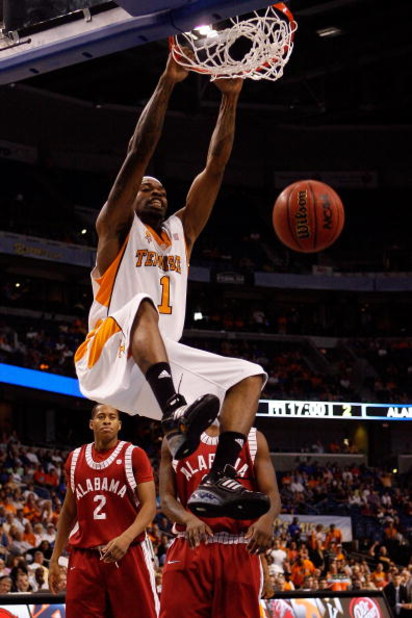 TAMPA, FL - MARCH 13:  Tyler Smith #1 of the Tennessee Volunteers dunks the ball over Mikhail Torrance #2 of the Alabama Crimson Tide during the quaterfinal round of the SEC Men's Basketball Tournament on March 13, 2009 at The St. Pete Times Forum in Tamp