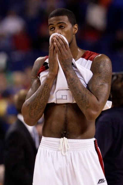 INDIANAPOLIS - MARCH 29: Earl Clark #5 of the Louisville Cardinals covers his face with his jersey in the final minute of their 64-52 loss against the Michigan State Spartans during the fourth round of the NCAA Division I Men's Basketball Tournament at t