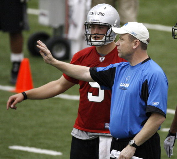 ALLEN PARK, MI - MAY 01: Offensive coordinator Scott Linehan of the Detroit Lions talks with Matthew Stafford #9 during rookie orientation camp at the Detroit Lions Headquarters and Training Facility on May 1, 2009 in Allen Park, Michigan.  (Photo by Greg