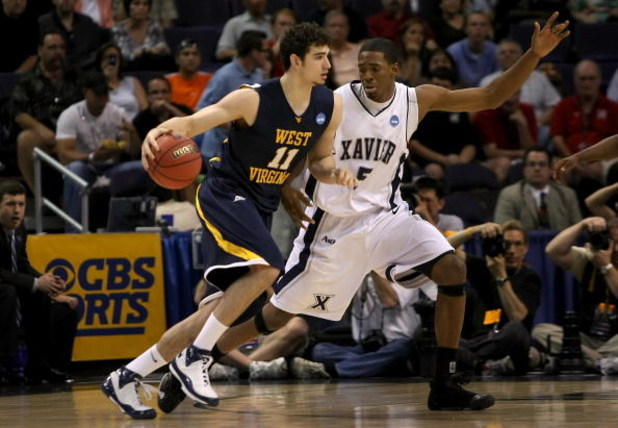 PHOENIX - MARCH 27:  Joe Alexander #11 of West Virginia Mountaineers dribbles the ball past Derrick Brown #5 of the Xavier Musketeers in the West Regional Sweet 16 game at the U.S. Airways Center on March 27, 2008 in Phoenix, Arizona.  (Photo by Stephen D