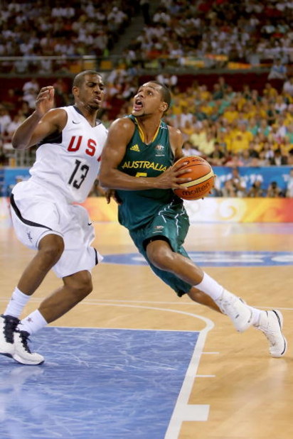 BEIJING - AUGUST 20:  Patrick Mills #5 of Australia drives to the basket over Chris Paul #13 of the United States during the men's basketball quarterfinal game at the Olympic Basketball Gymnasium during Day 12 of the Beijing 2008 Olympic Games on August 2