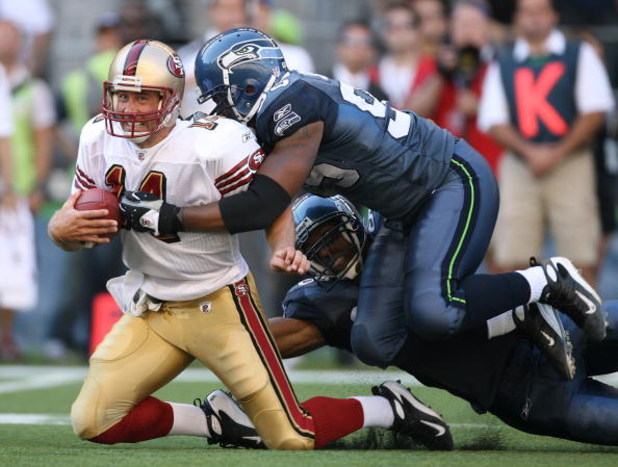 SEATTLE - SEPTEMBER 14:  Quarterback J.T. O'Sullivan #14 of the San Francisco 49ers is tackled by Lawrence Jackson #95 of the Seattle Seahawks after rushing for 12 yards in the fourth quarter on September 14, 2008 at Qwest Field in Seattle Washington. The
