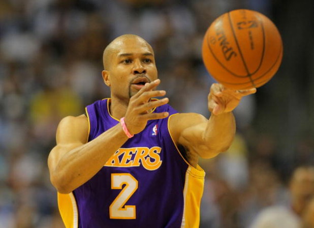 DENVER - MAY 23:  Derek Fisher #2 of the Los Angeles Lakers passes the ball against the Denver Nuggets in Game Three of the Western Conference Finals during the 2009 NBA Playoffs at Staples Center on May 23, 2009 in Denver, Colorado. NOTE TO USER: User ex