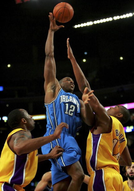 LOS ANGELES - JANUARY 12:  Dwight Howard #12 of the Orlando Magic goes up for a shot between Kobe Bryant #24 and Andrew Bynum #17 of the Los Angeles Lakers at Staples Center January 12, 2007 in Los Angeles, California. NOTE TO USER: User expressly acknowl