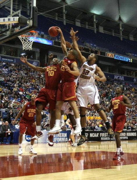 MINNEAPOLIS - MARCH 20:  DeMar DeRozan #10 and Daniel Hackett #13 of the USC Trojans fight for a rebound against Josh Southern #52 of the Boston College Eagles during the first round of the NCAA Division I Men's Basketball Tournament at the Hubert H. Hump