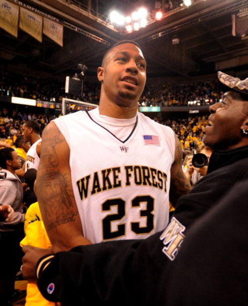 WINSTON-SALEM, NC - JANUARY 28:  James Johnson #23 of the Wake Forest Demon Deacons is mobbed by fans on the court after tipping in the game winning shot in the Deacons 70-68 win over the #1 ranked Duke Blue Devils in the final seconds of their game at La