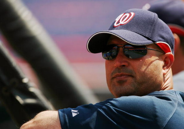 MIAMI - APRIL 06:  Manager Manny Acta #14 of he Washington Nationals watches his team go through warm-ups before taking on the Florida Marlins on opening day at Dolphin Stadium on April 6, 2009 in Miami, Florida.  (Photo by Doug Benc/Getty Images)
