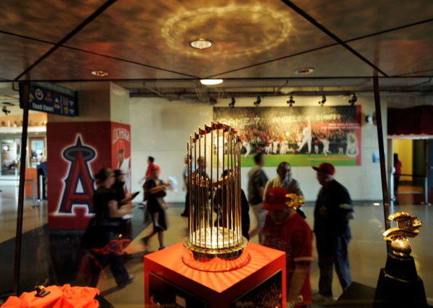 ANAHEIM, CA - APRIL 06:  Fans look at the 2002 World Series trophy of Los Angeles Angels at Angels Stadium of Anaheim after the gates opened for the Los Angeles Angels home opener against the Oakland Athletics on opening day April 6, 2009 in Anaheim, Cali